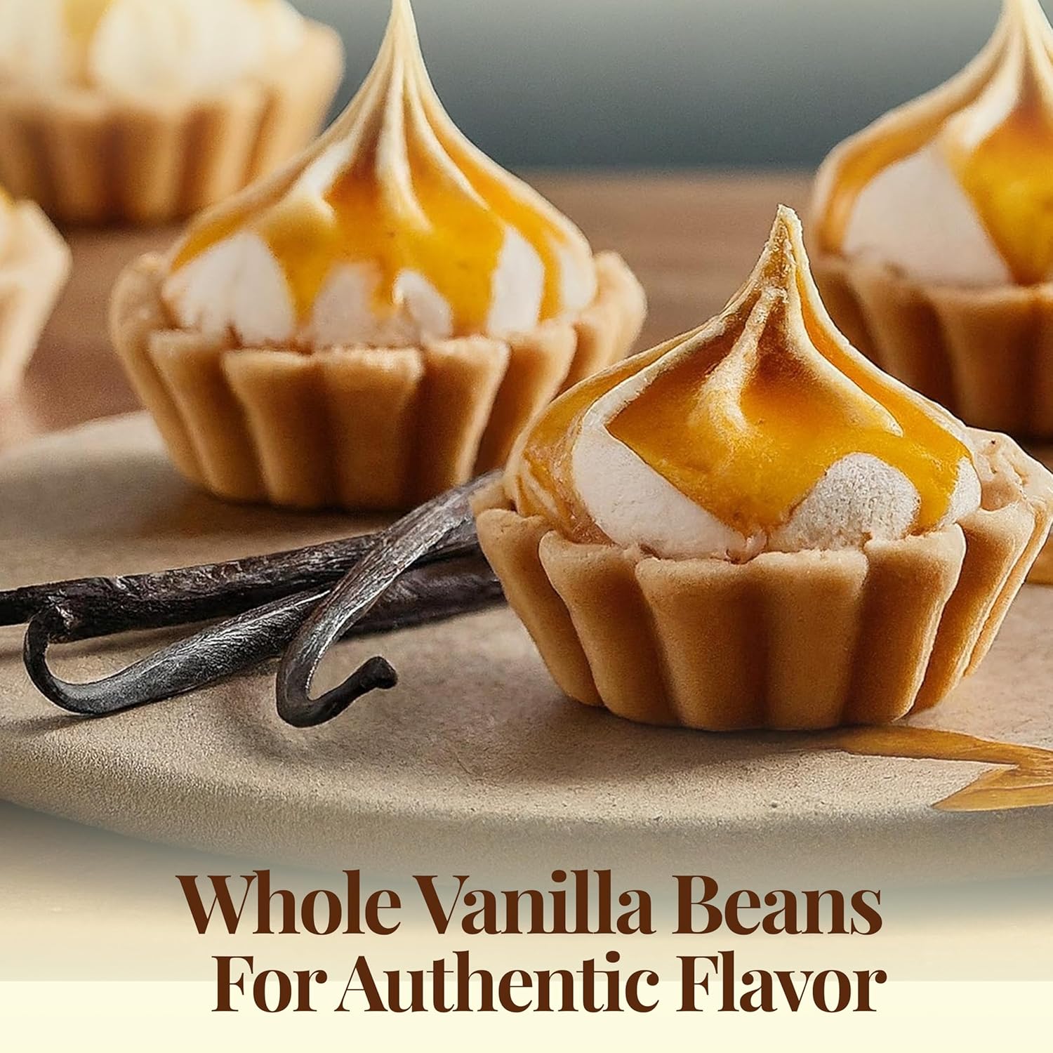 Vanilla beans with mini desserts topped with cream and caramel showing rich authentic flavor perfect for baking and gourmet treats